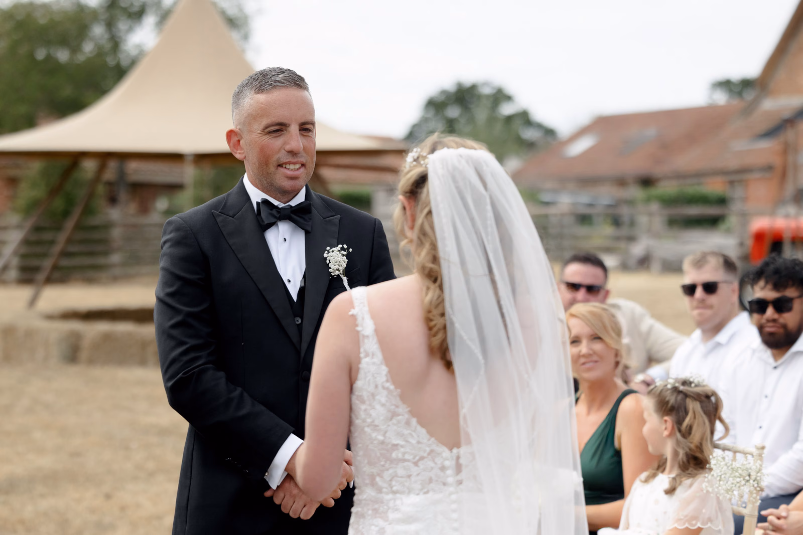 Groom and bride vows smiling at a family farm wedding in Taunton