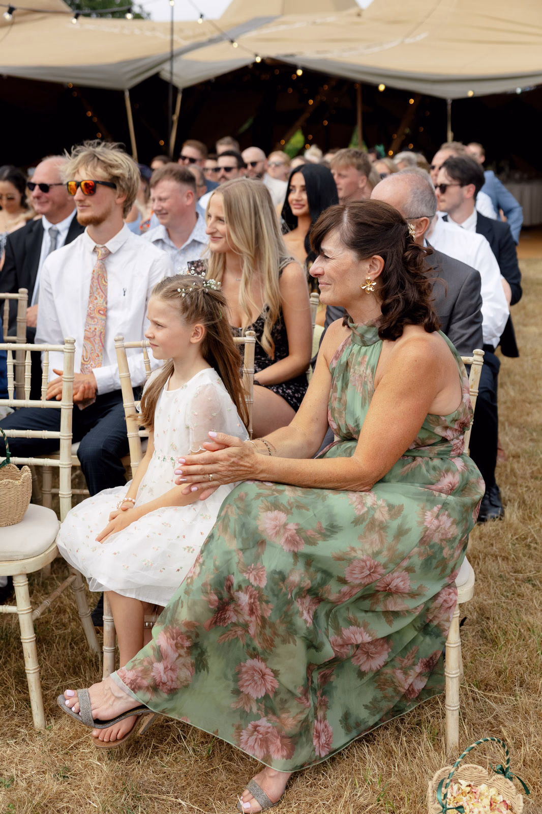 Flower girl and guest watching ceremony at a family farm wedding in Taunton