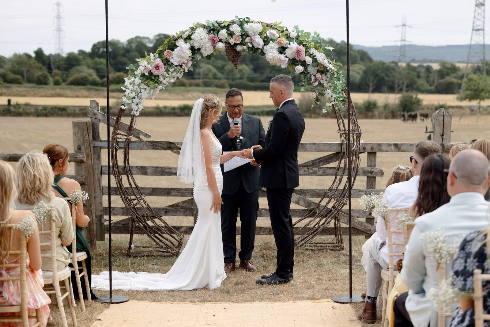 Exchanging rings ceremony at a family farm wedding in Taunton
