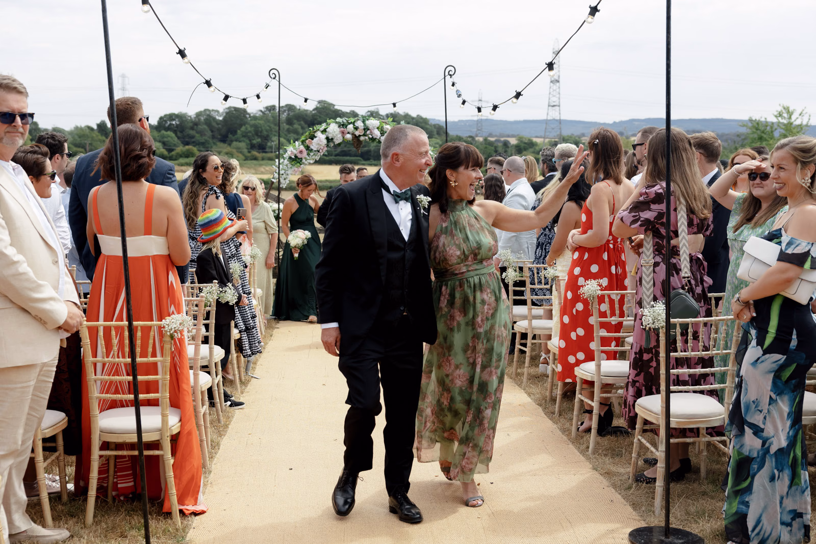 Parents walking down aisle after ceremony at a family farm wedding in Taunton