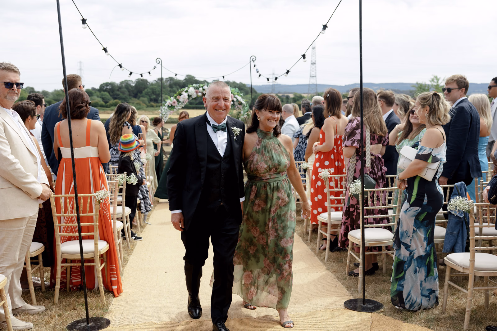 Parents walking aisle after ceremony smiling at a Taunton farm wedding, photographed by Tanya Bogdan Photography