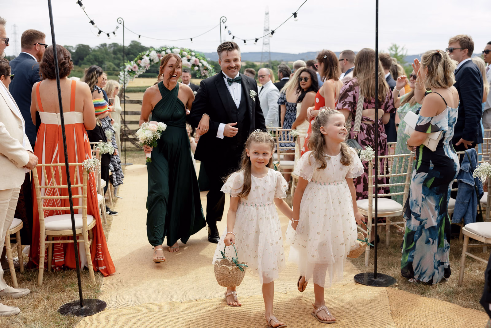 Flower girls walking aisle after ceremony at a countryside wedding in Taunton, Somerset
