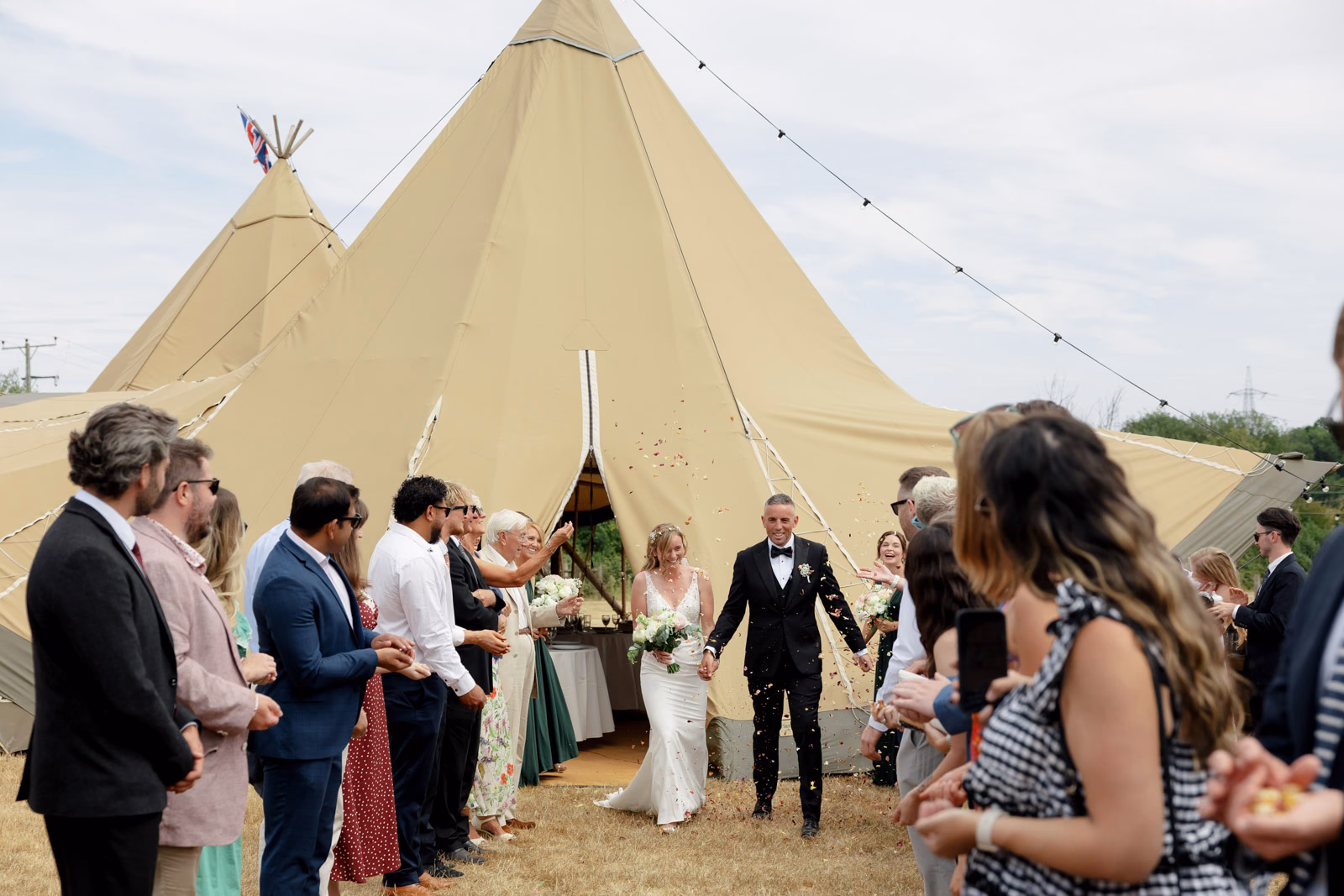 Newlyweds greeted by guests after ceremony at a family farm wedding in Taunton