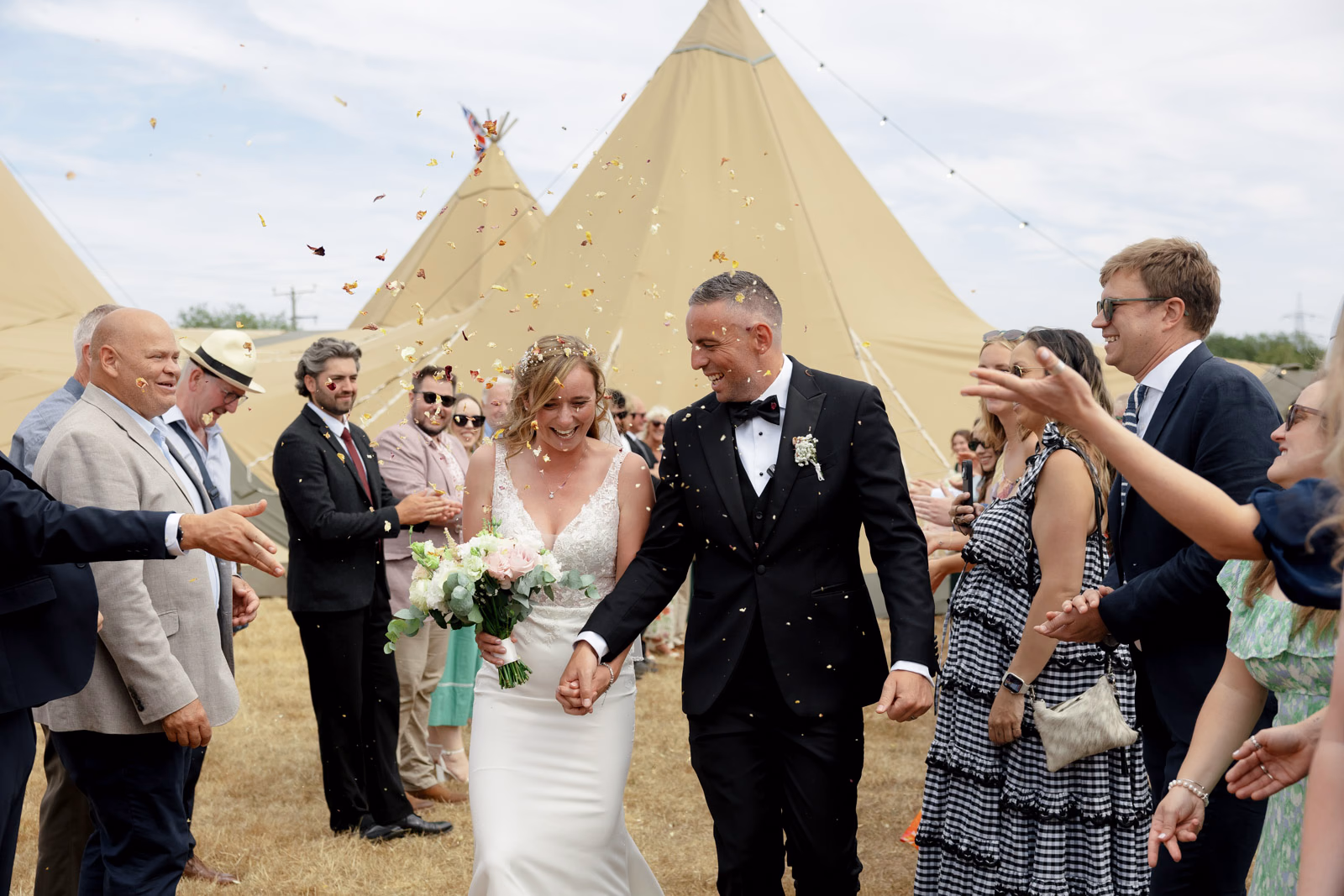 Newlyweds hugs and congratulations guests at a countryside wedding in Taunton, Somerset