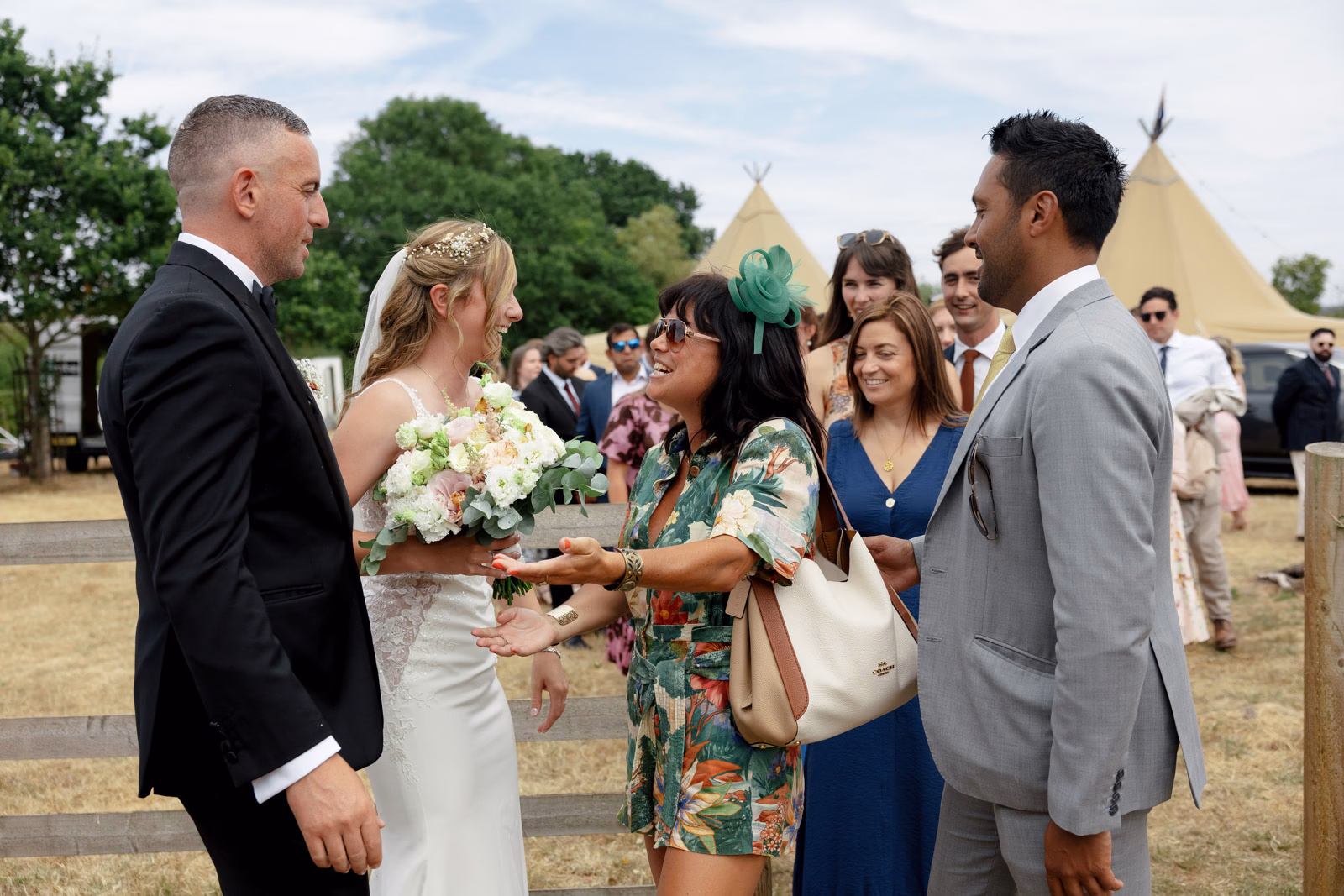 Bride hugging guests congratulations at a Taunton farm wedding, photographed by Tanya Bogdan Photography