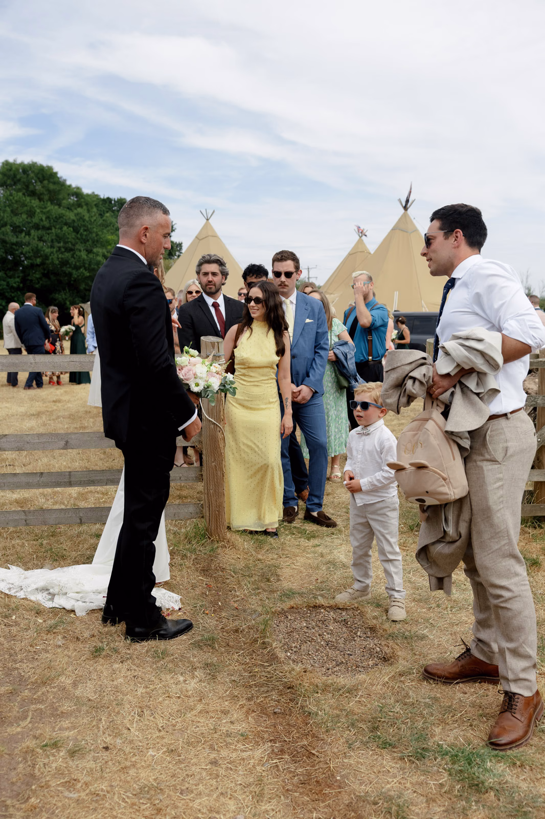 Groom greeting guests after ceremony at a family farm wedding in Taunton