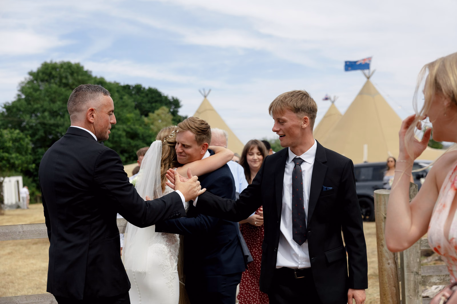 Groom hugging guest congratulations at a countryside wedding in Taunton, Somerset