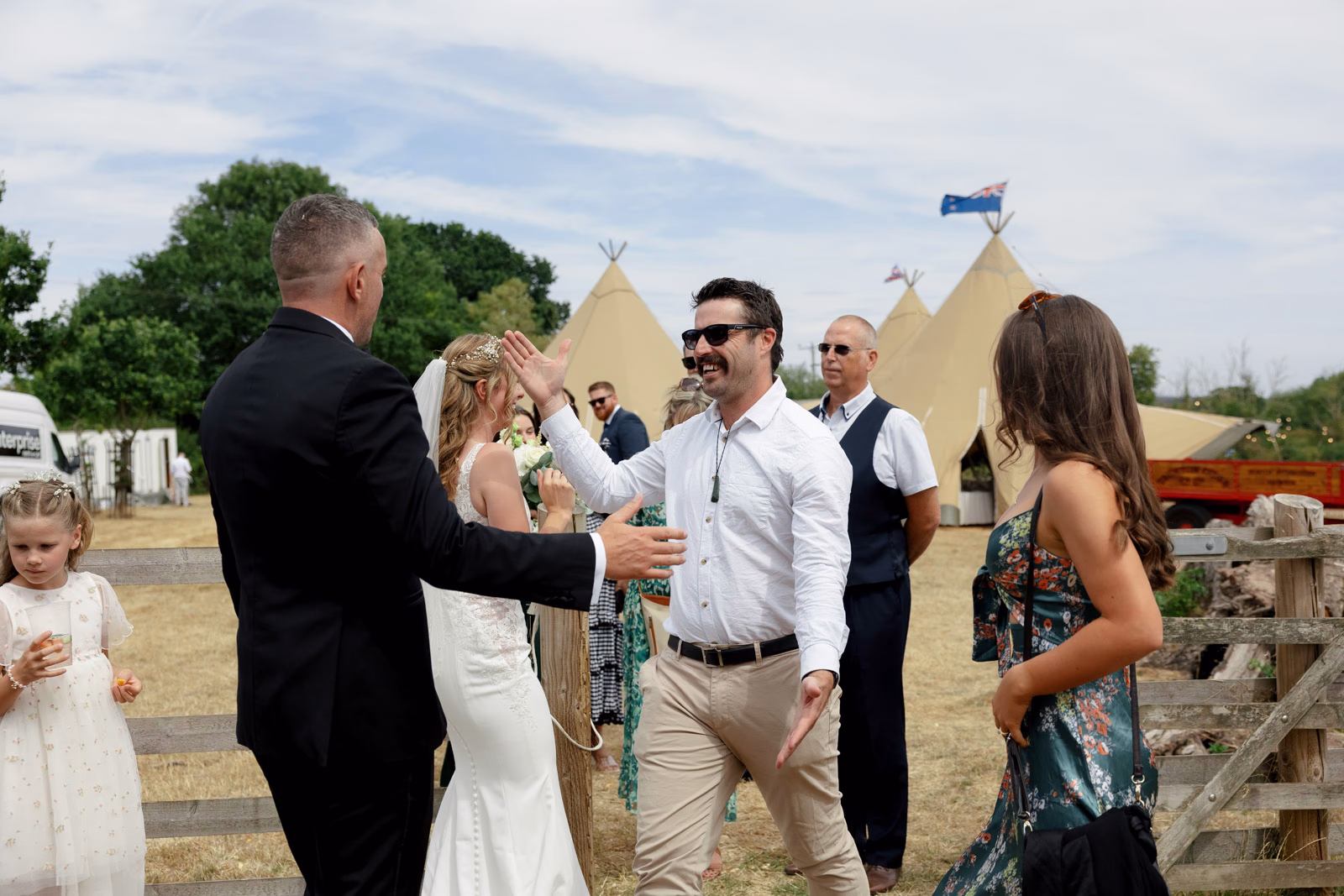 Groom hugging guest after ceremony at a Taunton farm wedding, photographed by Tanya Bogdan Photography