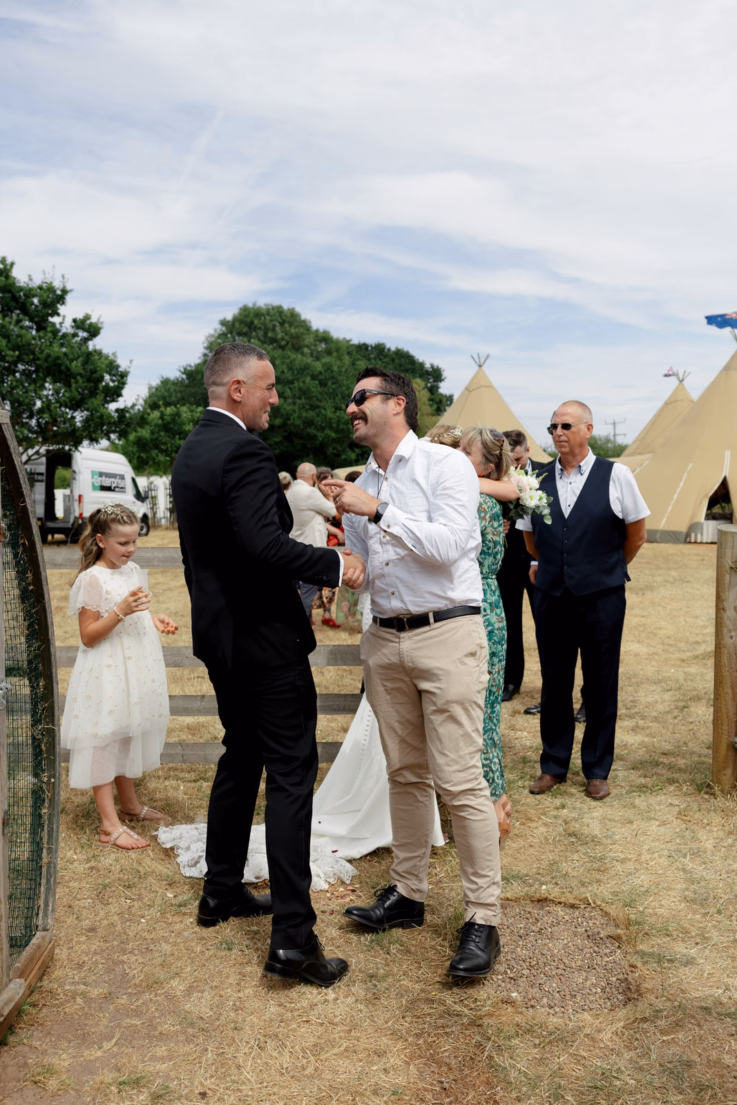 Groom chatting with guests after ceremony at a countryside wedding in Taunton, Somerset