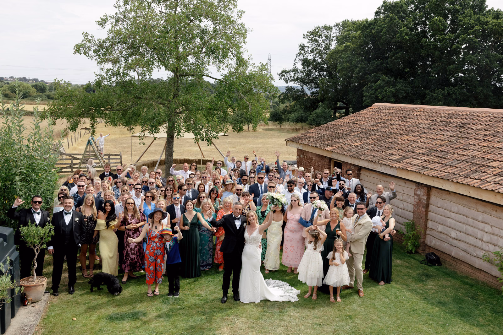 Group photo all wedding guests at a family farm wedding in Taunton