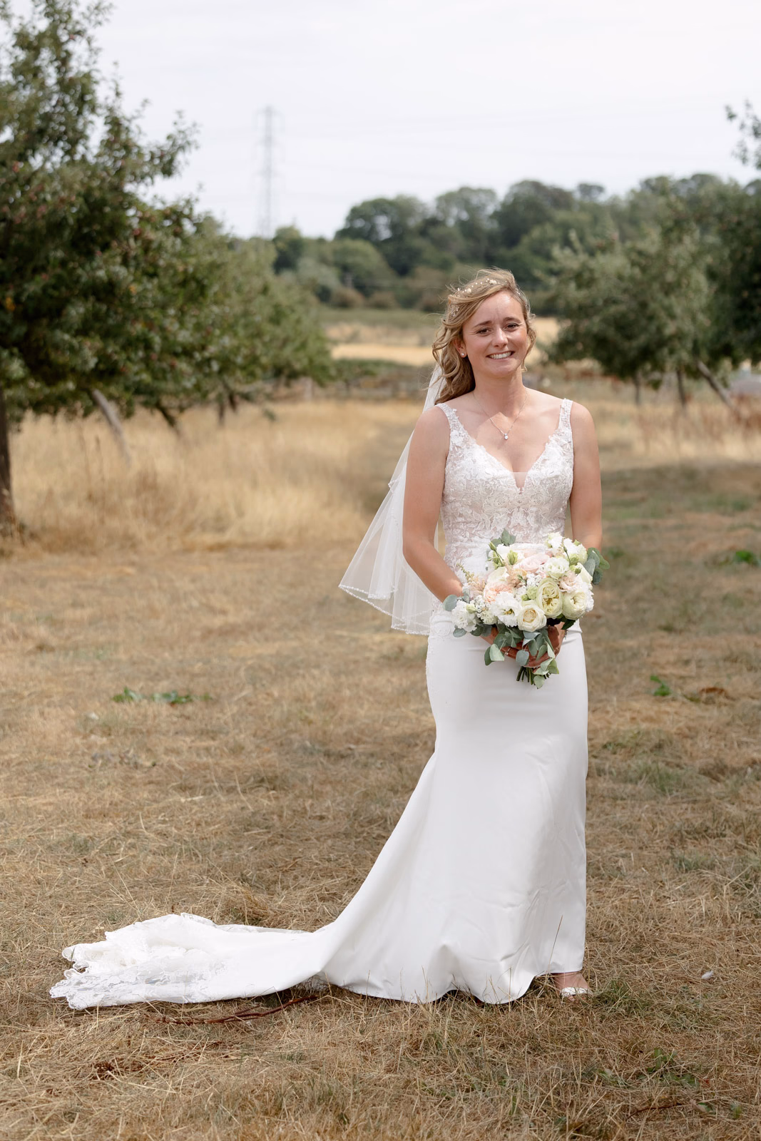 Bride portrait full-length field at a family farm wedding in Taunton