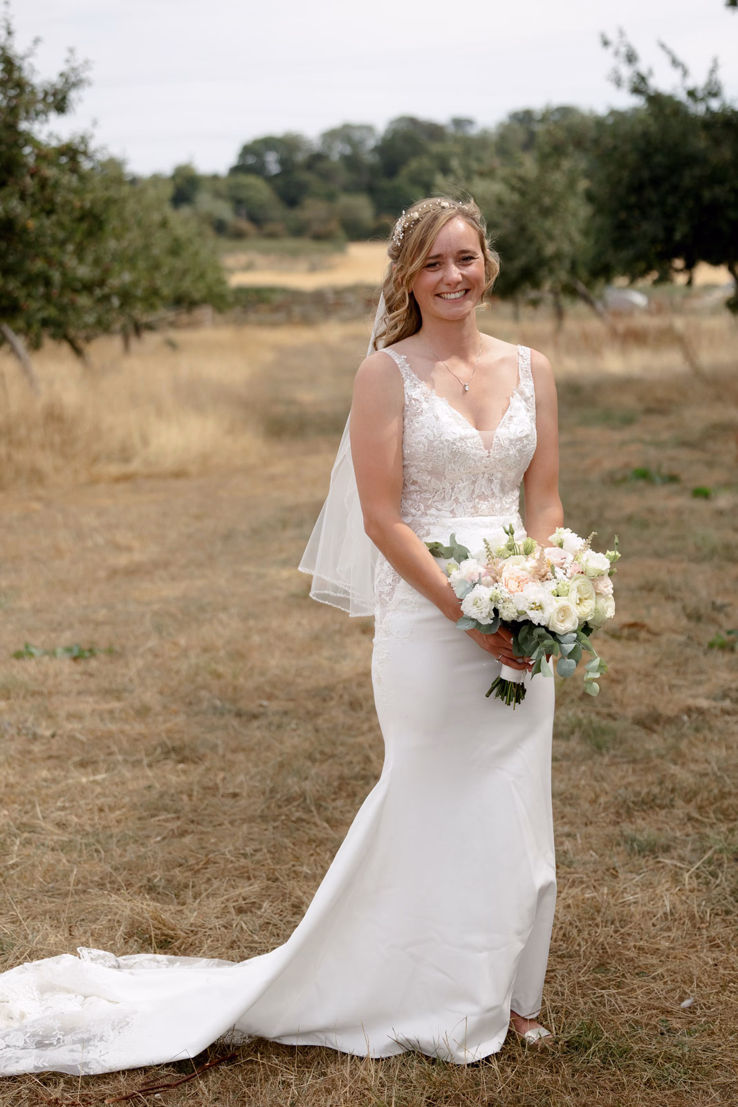 Bride portrait wedding dress train at a family farm wedding in Taunton