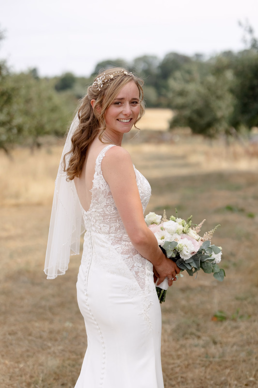 Bride portrait looking over shoulder at a family farm wedding in Taunton