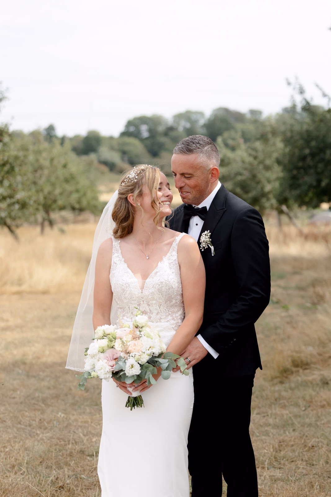 Bride and groom embrace portrait at a family farm wedding in Taunton