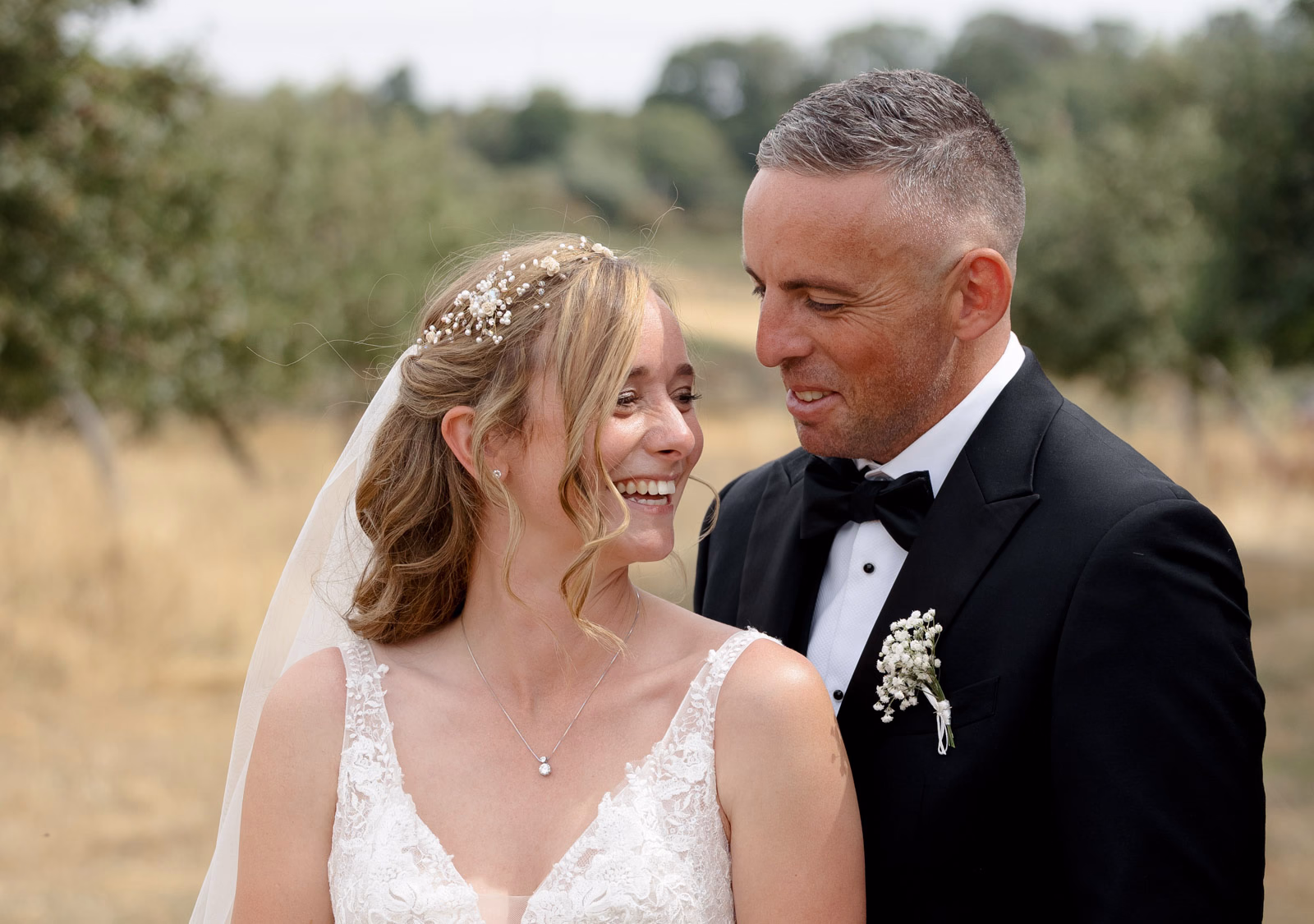 Bride and groom close-up smiling at a family farm wedding in Taunton