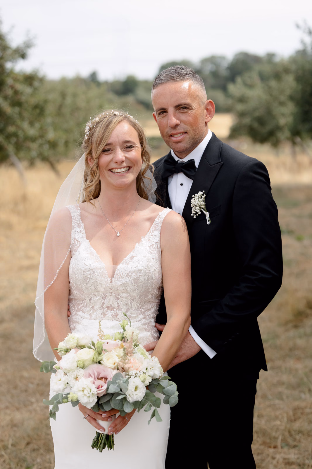 Bride and groom smiling portrait orchard at a countryside wedding in Taunton, Somerset