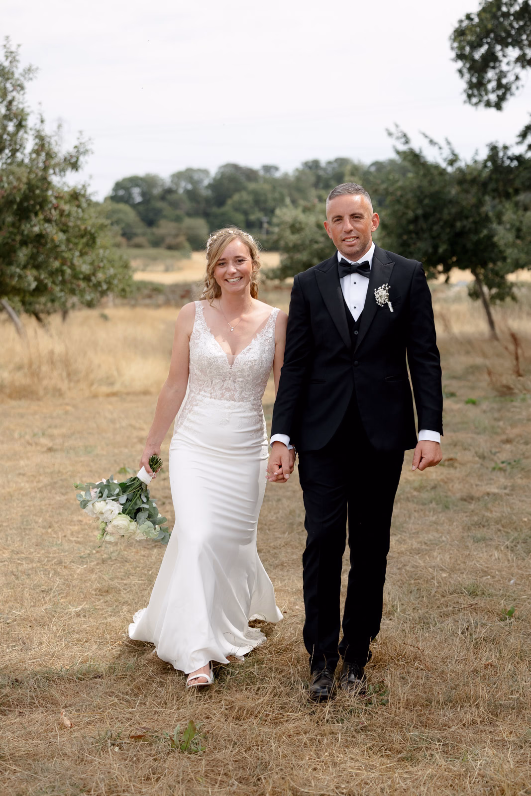 Bride and groom walking together countryside at a countryside wedding in Taunton, Somerset