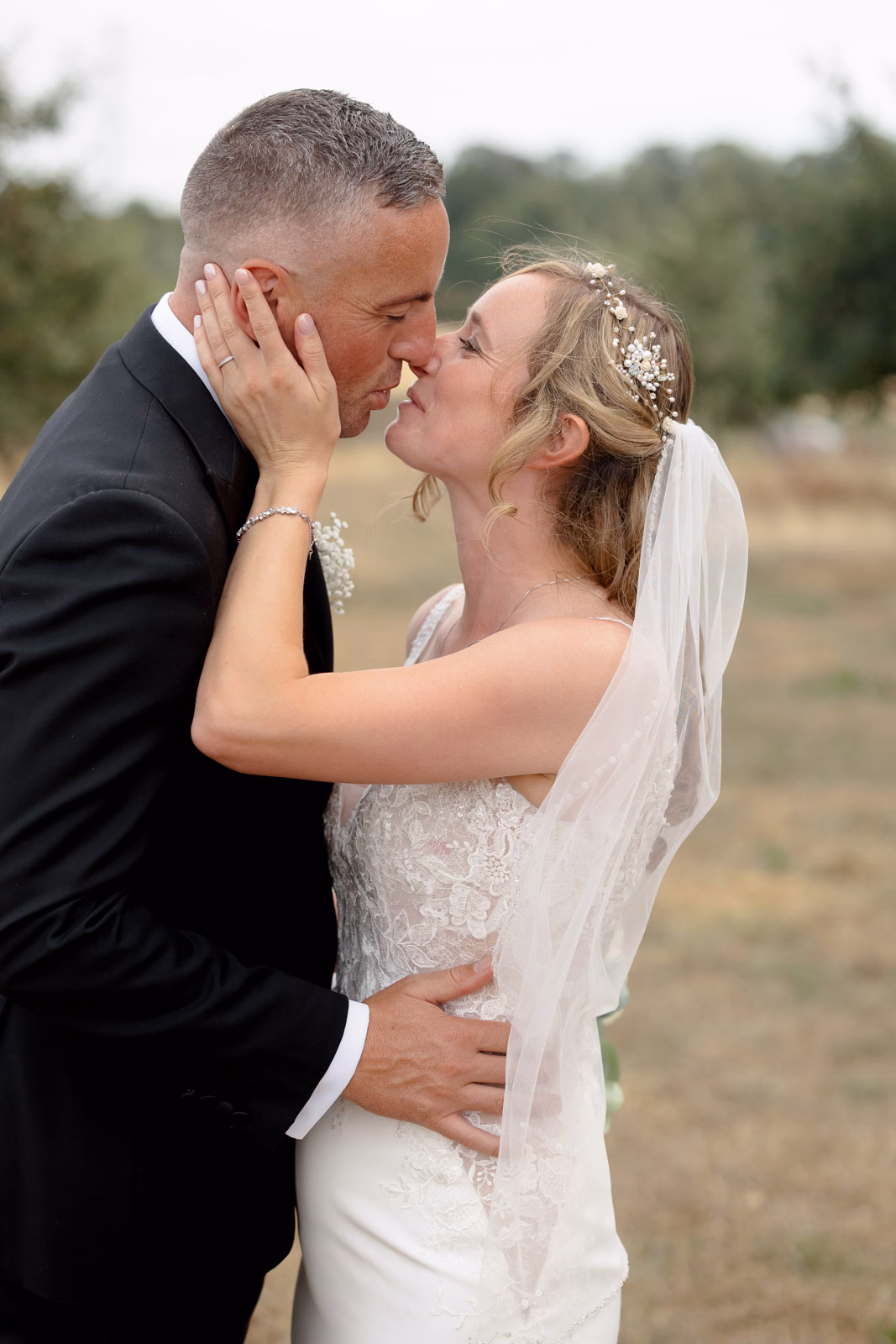 Bride and groom kiss portrait at a family farm wedding in Taunton