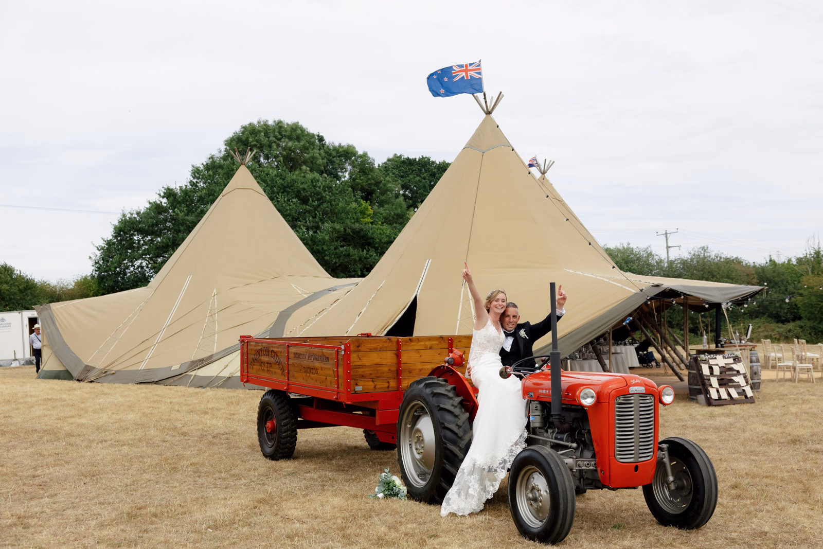 Bride cheering on red tractor at a countryside wedding in Taunton, Somerset