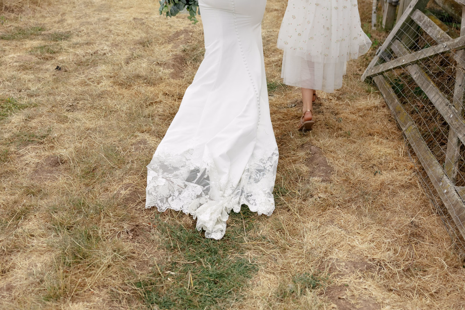 Wedding dress detail walking in grass at a family farm wedding in Taunton