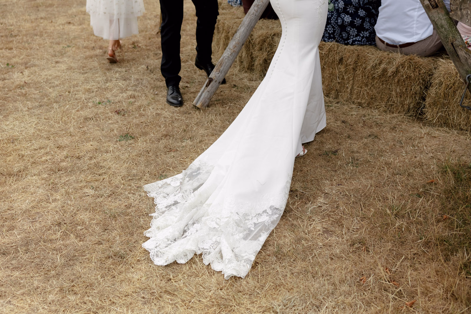 Lace dress train detail at a family farm wedding in Taunton