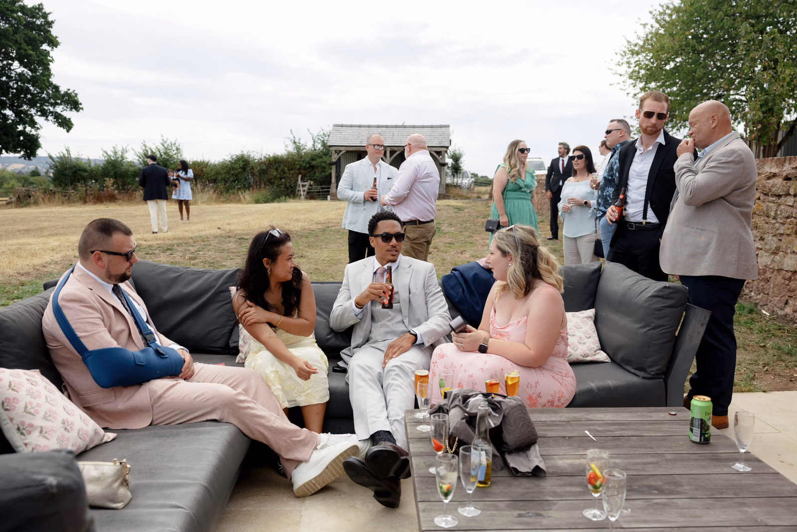 Guests relaxing lounge seating drinks at a countryside wedding in Taunton, Somerset