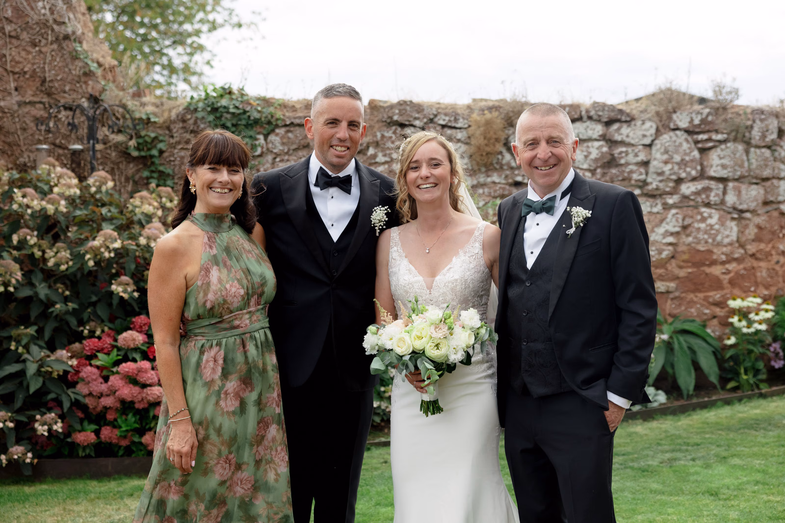 Bride groom family photo walled garden at a Taunton farm wedding, photographed by Tanya Bogdan Photography