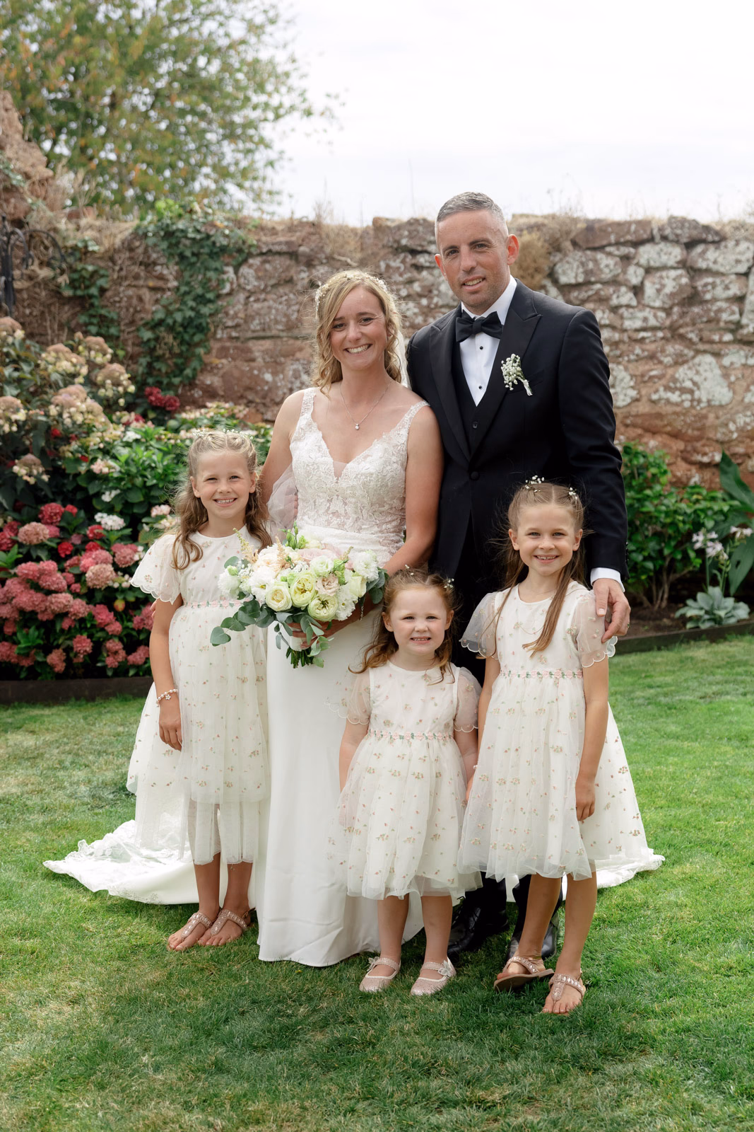 Bride with flower girls walled garden at a countryside wedding in Taunton, Somerset