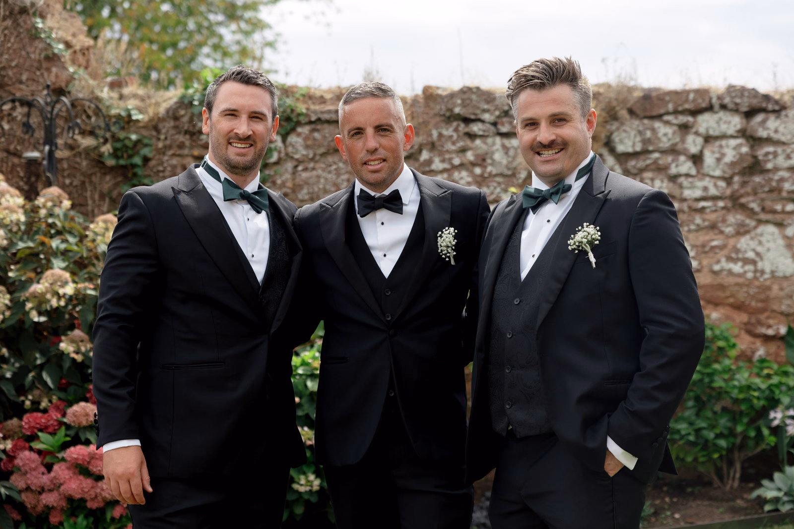 Groom and groomsmen close-up walled garden at a family farm wedding in Taunton