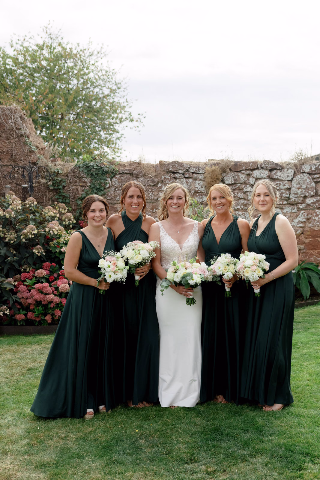Bride with bridesmaids walled garden at a countryside wedding in Taunton, Somerset