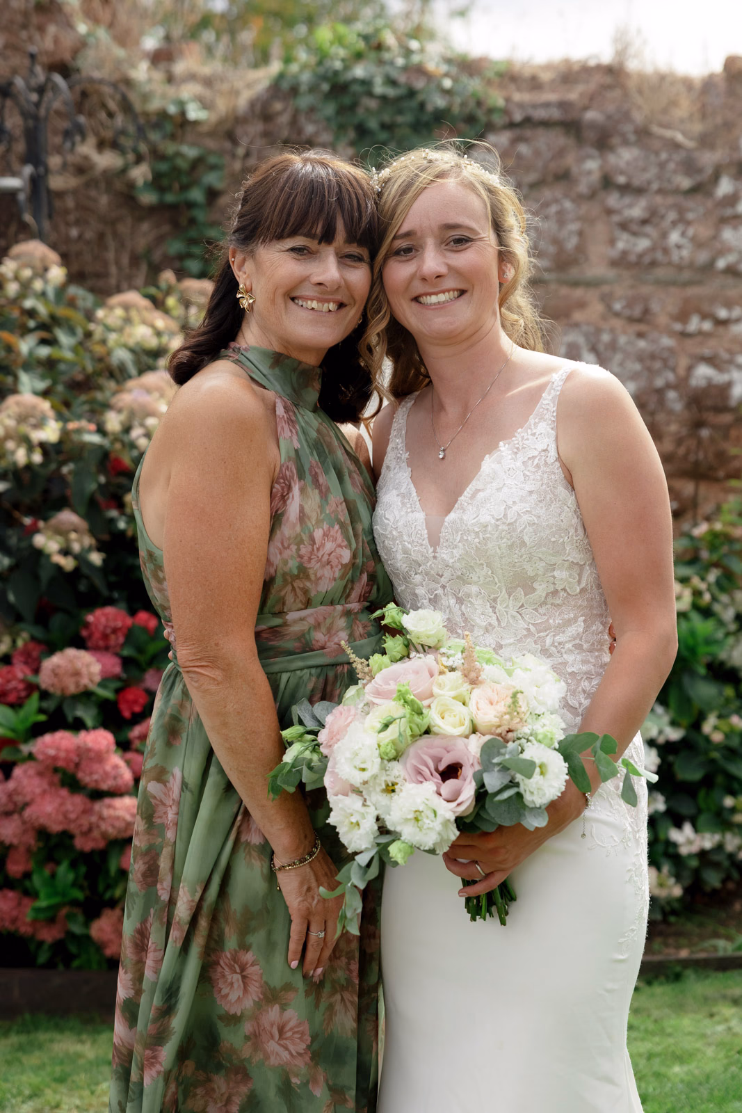 Bride and guest smiling portrait at a family farm wedding in Taunton