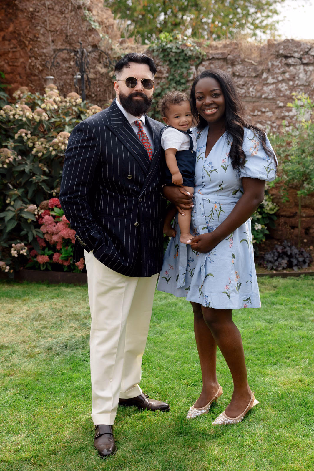 Guests portrait with baby walled garden at a Taunton farm wedding, photographed by Tanya Bogdan Photography