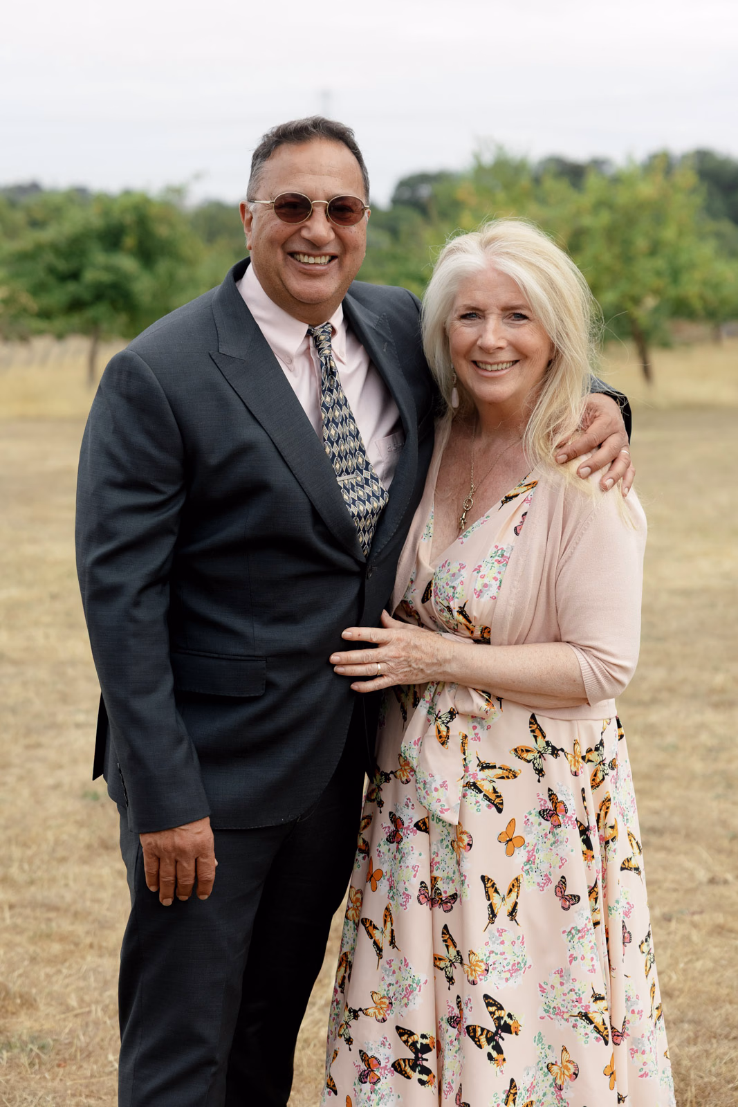 Guest couple portrait in field at a family farm wedding in Taunton