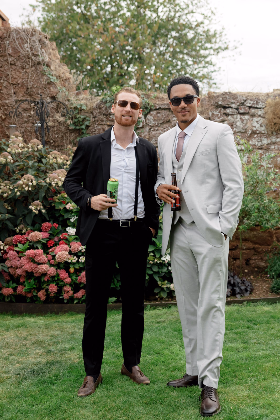 Guests with drinks portrait garden at a Taunton farm wedding, photographed by Tanya Bogdan Photography
