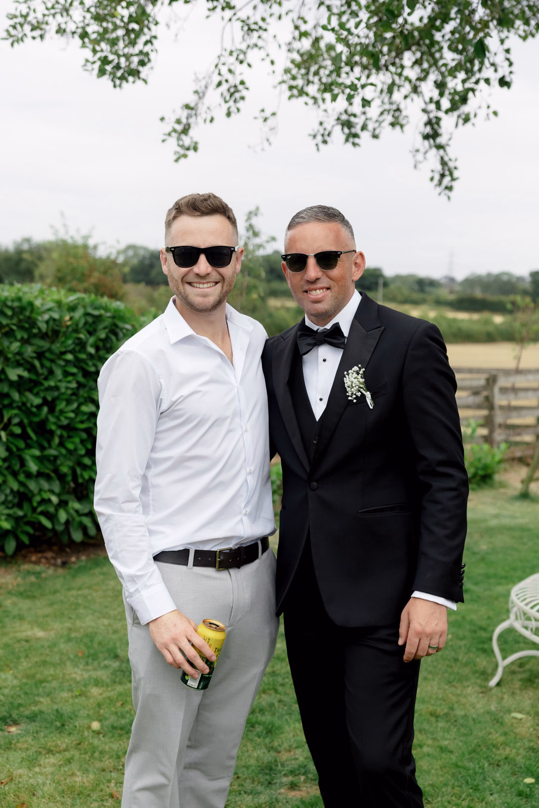 Groom with friend portrait garden at a family farm wedding in Taunton