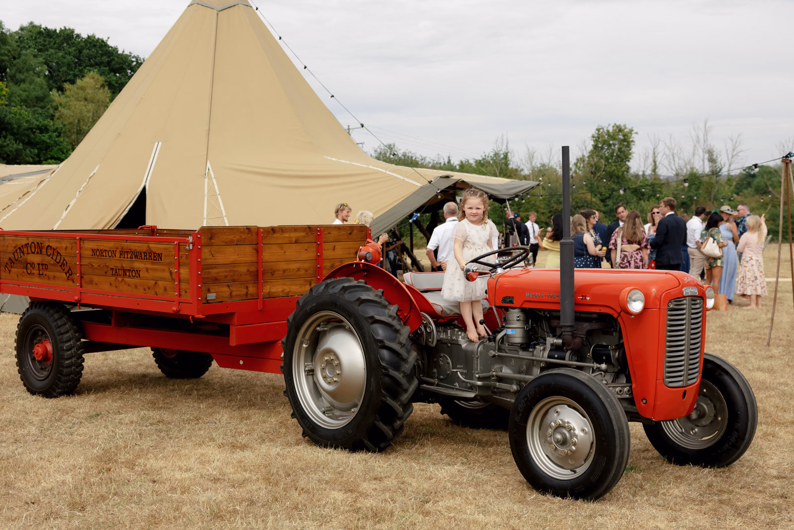 Vintage red tractor trailer tipi at a countryside wedding in Taunton, Somerset