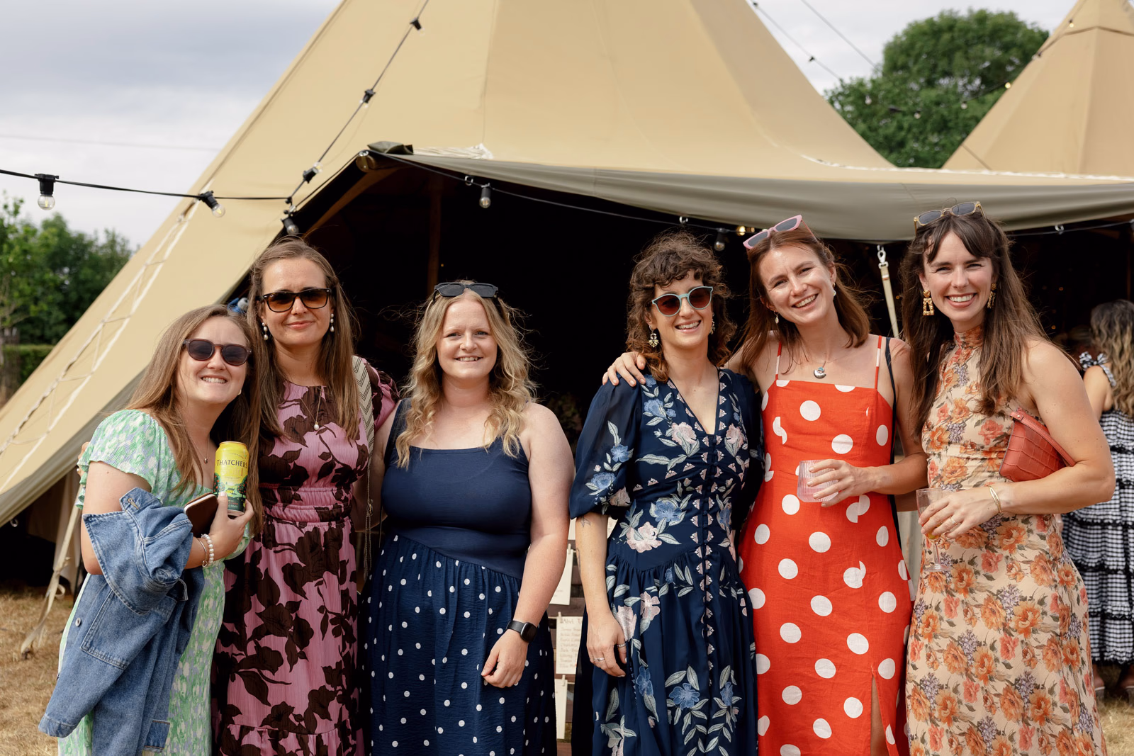 Group of friends smiling tipi at a family farm wedding in Taunton