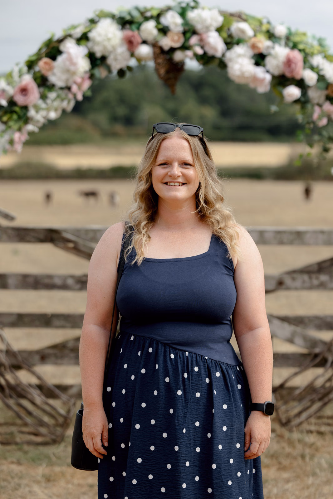 Guest portrait floral arch at a family farm wedding in Taunton