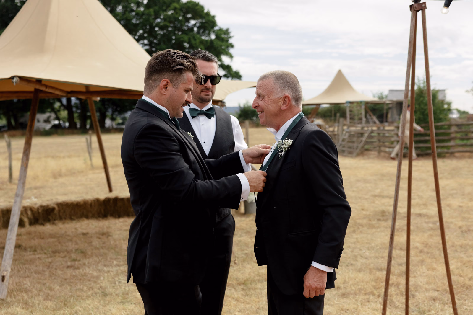 Groom chatting with guests tipi at a countryside wedding in Taunton, Somerset