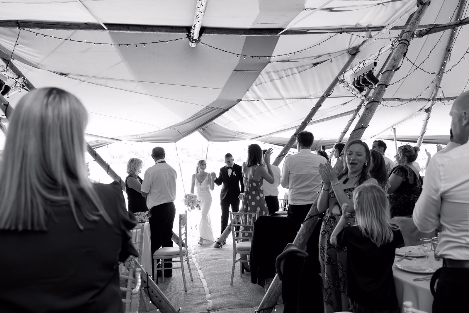 Guests entering wedding breakfast black-and-white at a family farm wedding in Taunton