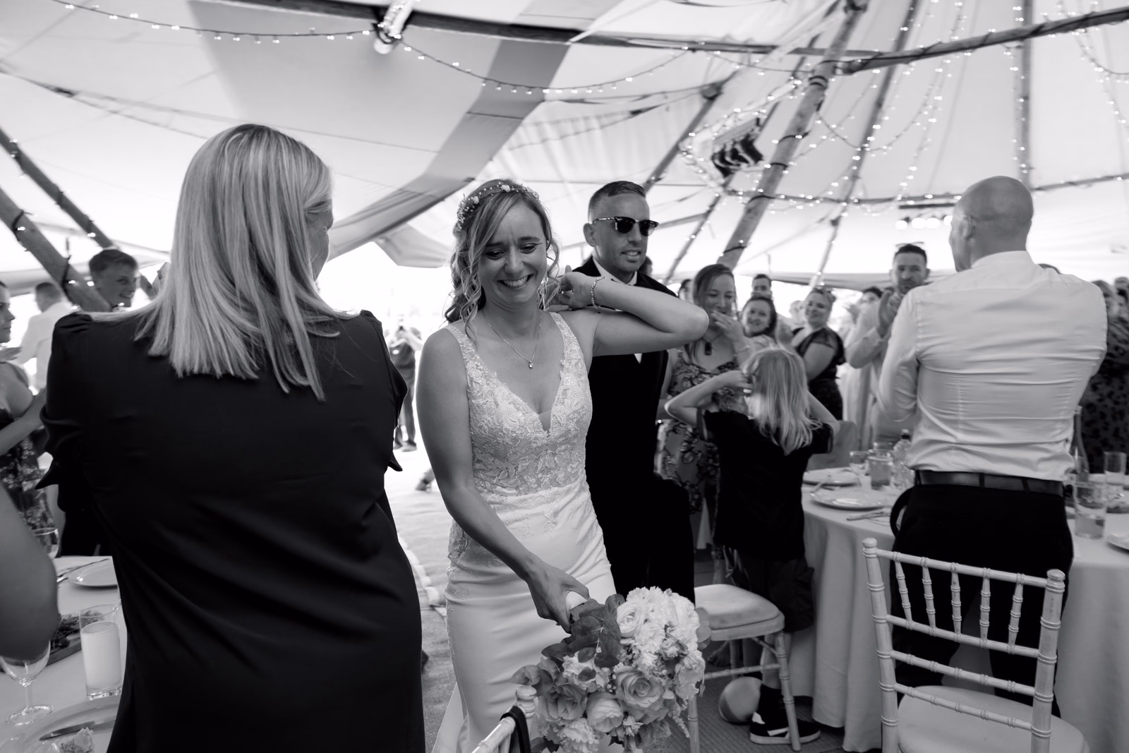 Bride entering wedding breakfast black-and-white at a family farm wedding in Taunton