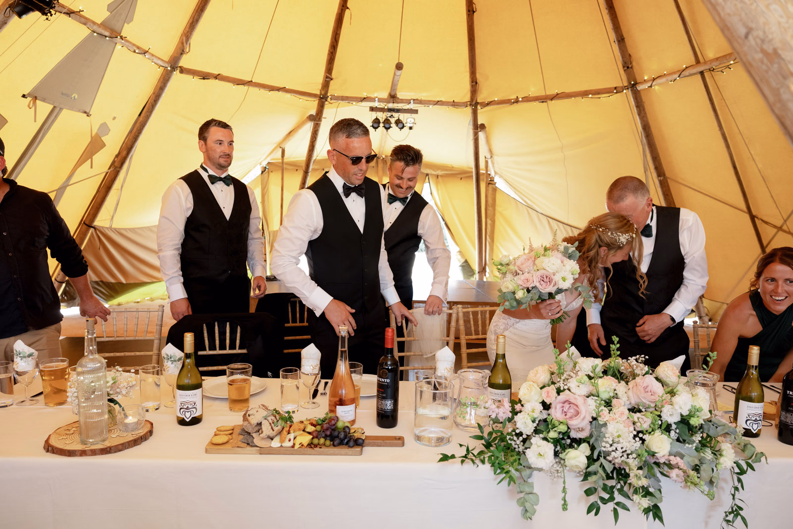 Top table groomsmen flowers tipi at a Taunton farm wedding, photographed by Tanya Bogdan Photography