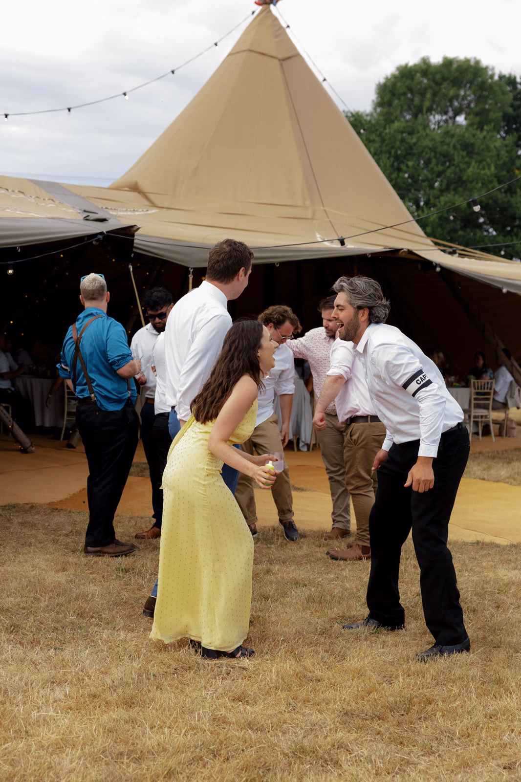 Guests dancing in field at a countryside wedding in Taunton, Somerset