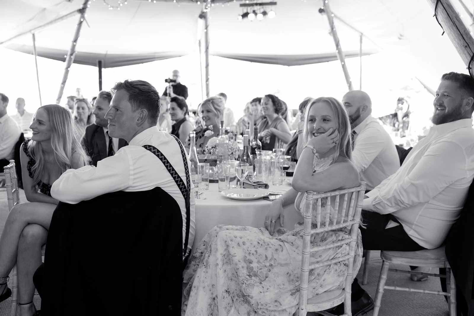 Guests laughing during speeches black-and-white at a countryside wedding in Taunton, Somerset