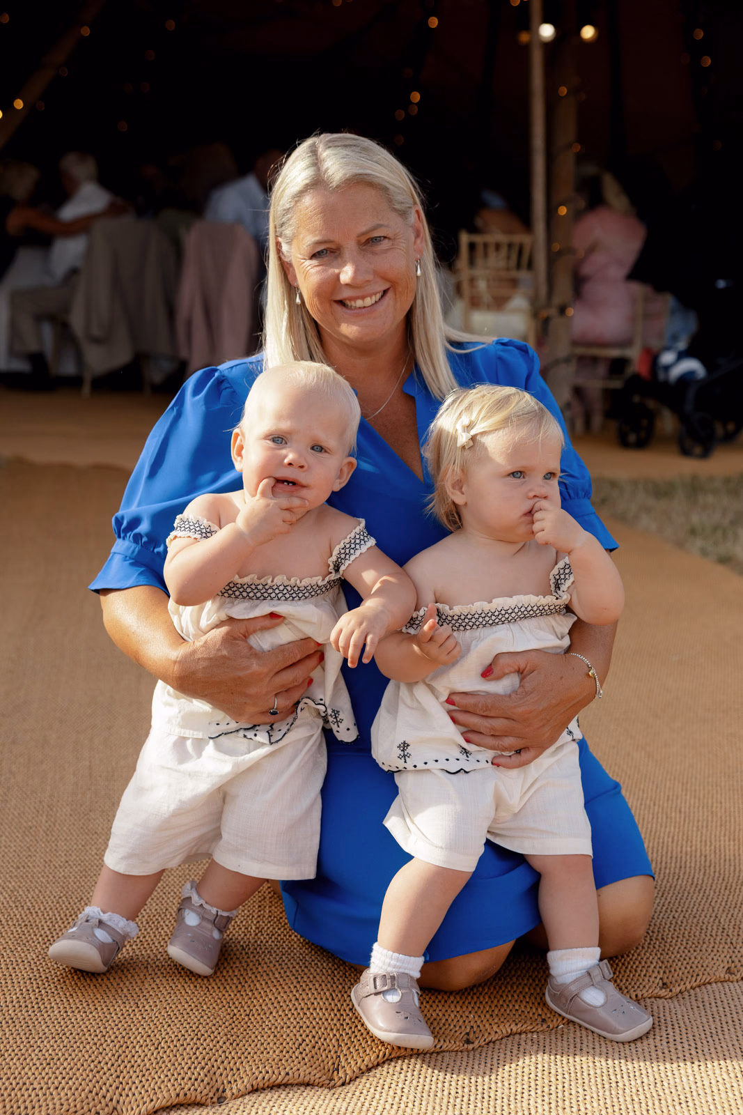Guest with twin babies at a family farm wedding in Taunton