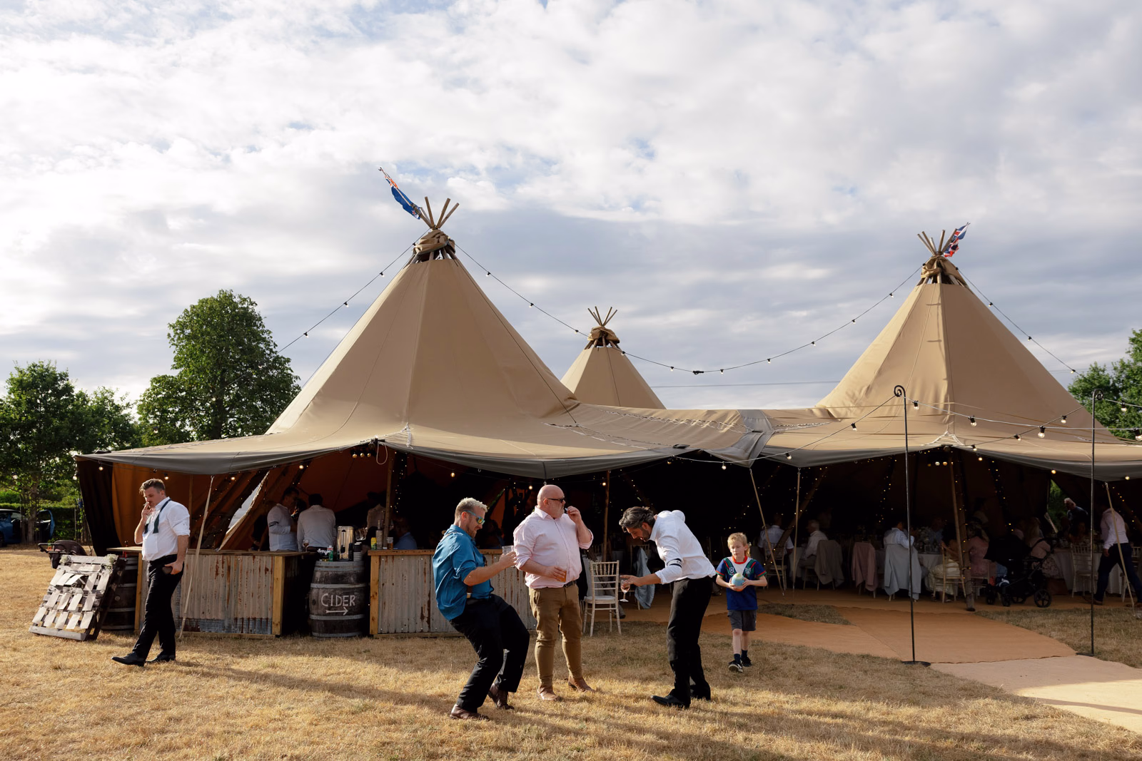 Tipi evening guests playing games at a Taunton farm wedding, photographed by Tanya Bogdan Photography