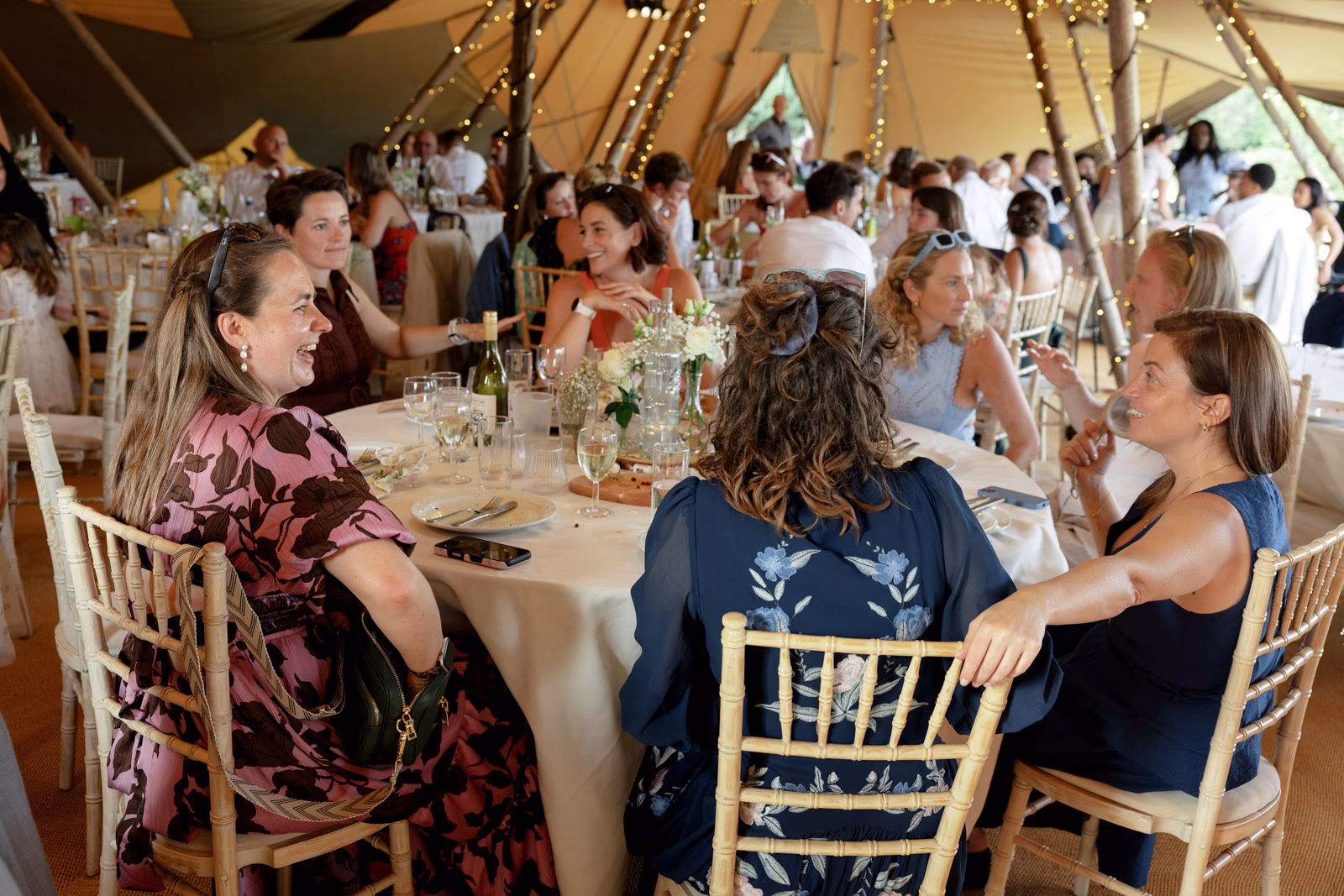 Guests seated wedding breakfast at a family farm wedding in Taunton