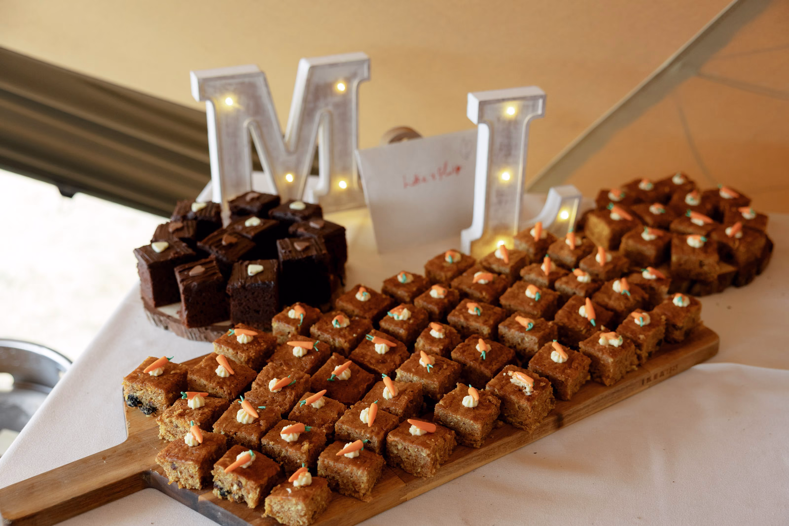 Brownie dessert table initials at a family farm wedding in Taunton