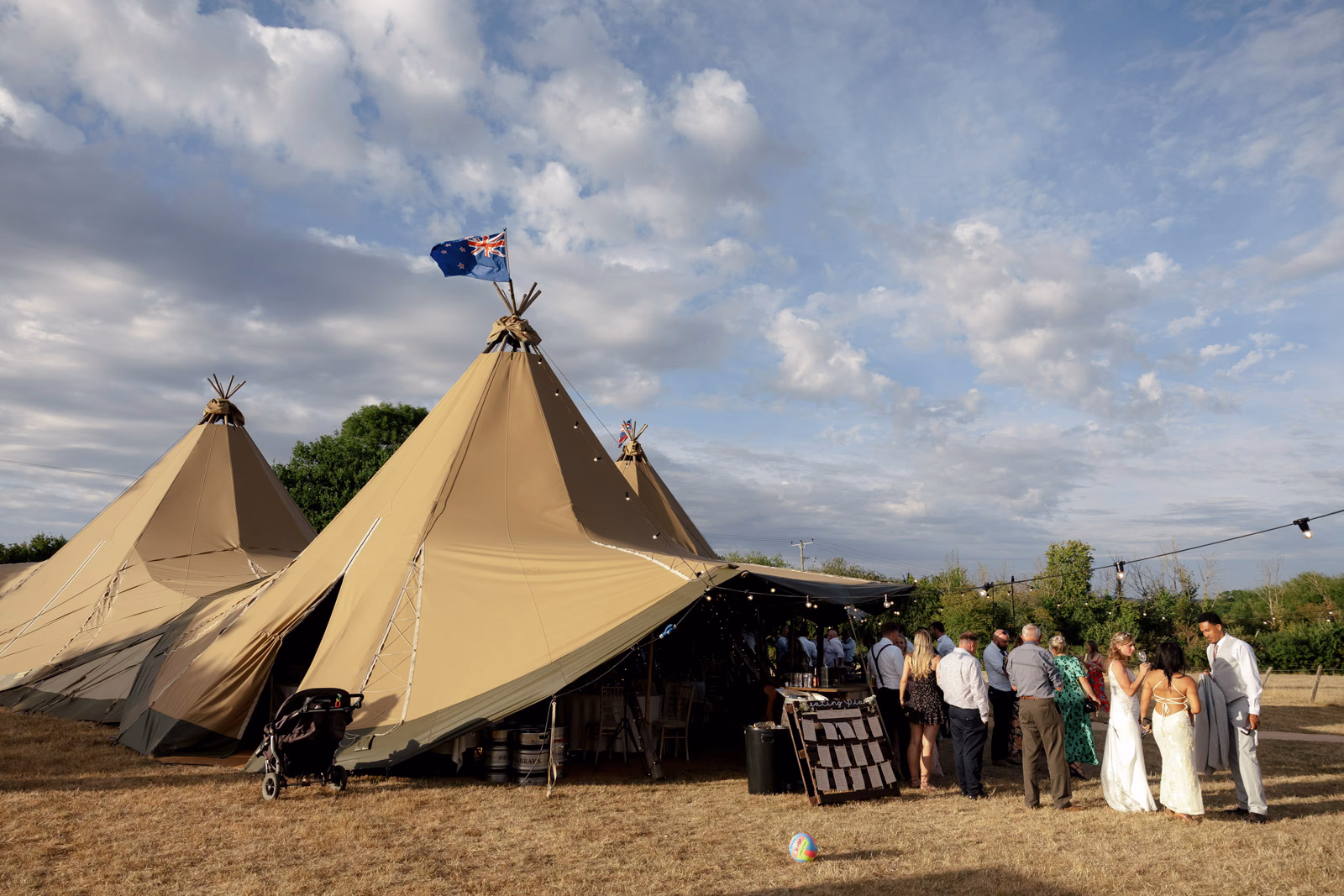 Tipi evening sky guests at a Taunton farm wedding, photographed by Tanya Bogdan Photography