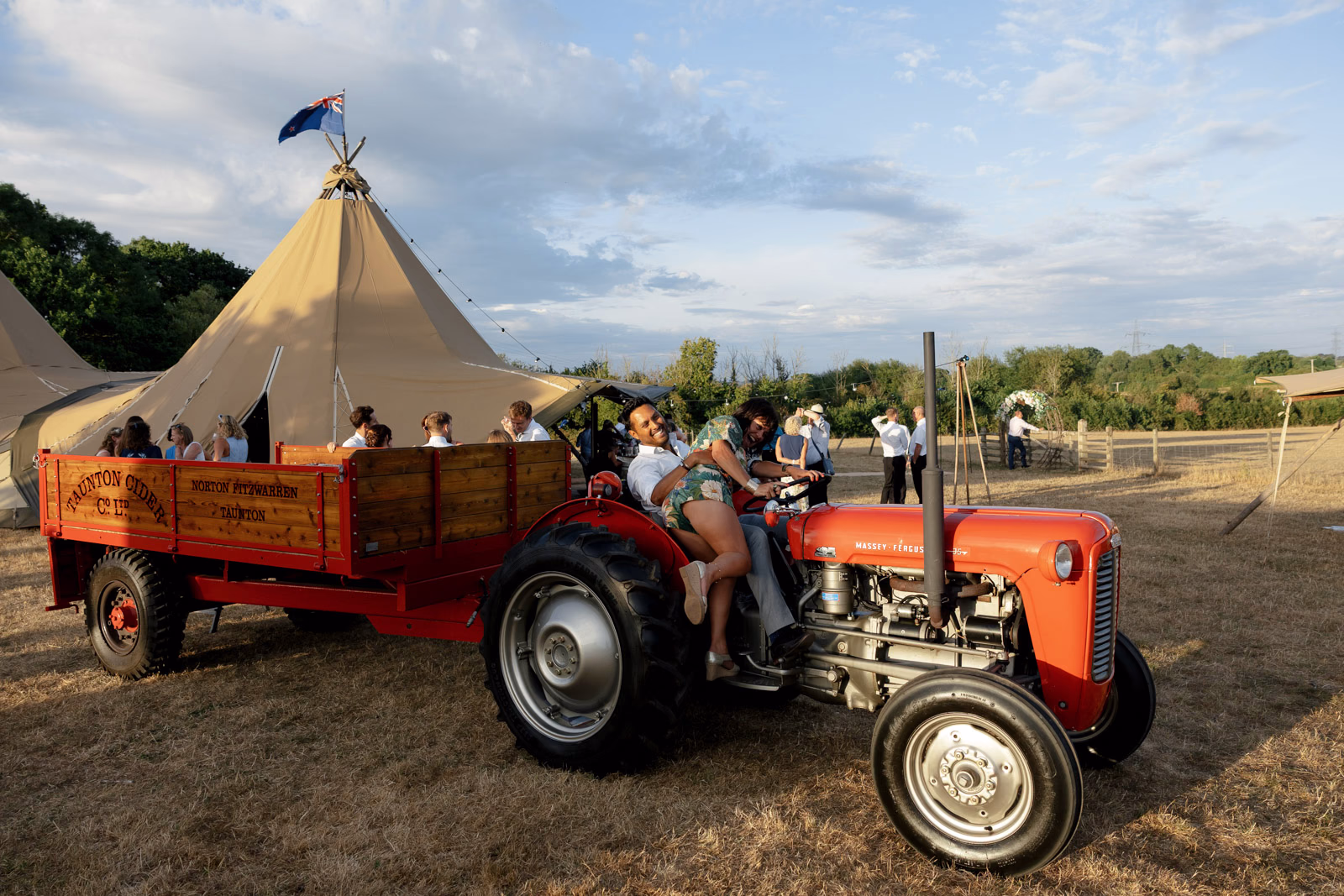 Guests tractor trailer ride at a family farm wedding in Taunton